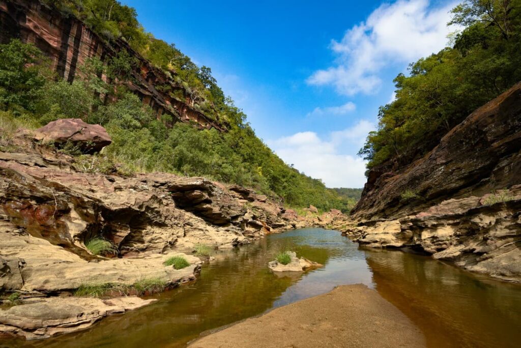 A view of a hill stream in the higher reaches of the Satpura hills flanked by rocky escarpments with occasional slivers of sand bars.A typical Eurasian otter habitat.